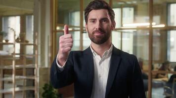 Happy business man looking at camera thumb up sign in office businessman raise finger good recommend company working Caucasian male smiling guy portrait employer approval gesture like vote respect video