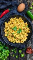 Spicy Scrambled Eggs with Fresh Herbs and Peppers. photo
