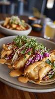 Delicious Crispy Fish Tacos with Creamy Sauce and Fresh Greens. photo