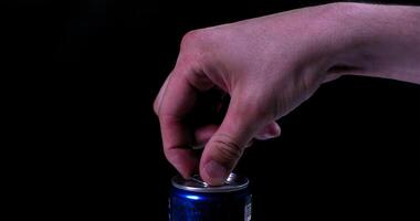 A person's hand holding a can of soda photo
