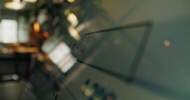A close up of a glass wall with a computer screen photo