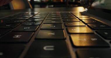 A person typing on a laptop computer keyboard photo
