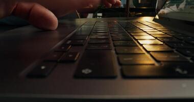 A person's hand is on a laptop keyboard photo