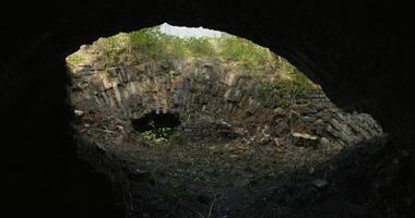 An old tunnel with a light coming from it photo