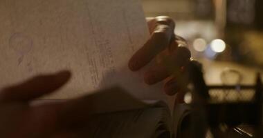 A person holding a piece of paper with a pen in their hand photo
