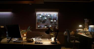 A dark room with a desk and a lamp photo