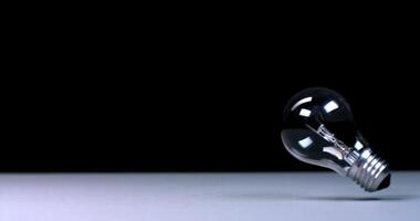 A light bulb is shown on a table photo