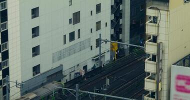 A train is traveling down a track next to a building video