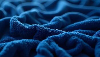 Close-up of Soft Blue Towel Texture with Deep Folds and Shadows photo