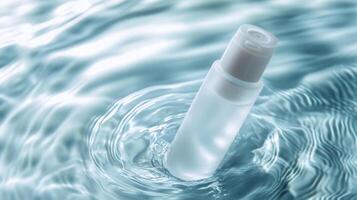 Glass cosmetic dropper bottle creating partially submerged, floating tranquil water ripples with soft frosted surface photo