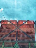 Stacked Plastic Crates on Truck Under Sunny Blue Sky for Transport photo
