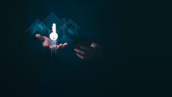 Businessman showing key icon to communicate real estate trading or loan application, home loan, investment concept for growing returns in the real estate market, interest rates, mortgage. photo