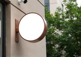 Logo Mockup on a Round Exterior Sign Mounted on the Wall photo