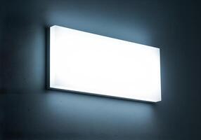 Rectangular Wall Light Fixture Illuminating a Textured Surface for Logo Mockup 1 photo