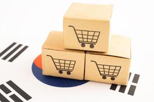 Box with shopping online cart logo and South Korea flag. photo