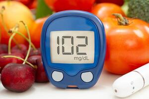 digital glucose monitor measure with vegetable and fruit photo