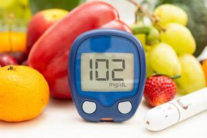 digital glucose monitor measure with vegetable and fruit food. photo