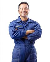 Portrait of a smiling mechanic in blue overalls with arms crossed against white background photo