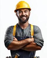 A smiling construction worker with arms crossed wearing a yellow hard hat and overalls suit photo