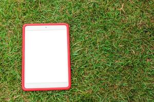 Tablet phone on the grass photo