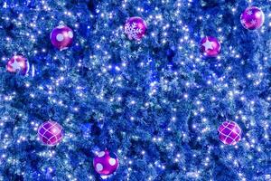 A christmas tree with many balls and lights photo