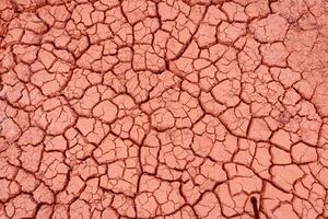 A close up of a cracked red surface photo