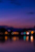 Blurred bokeh light background of the city at night photo
