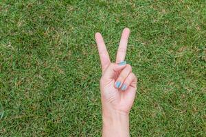 A person's hand is making the peace sign with their fingers photo