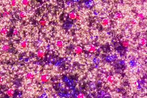 A christmas tree with many lights and red balls photo