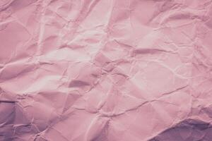 Crumpled paper background with pink color photo