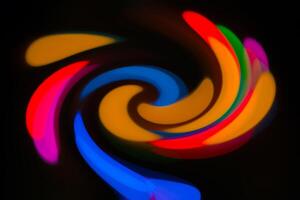 A colorful swirl of light in the dark photo