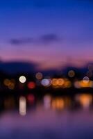 Blurred background of lights at night over water photo