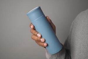 Reusable Water Bottle held in a person hand indoors photo