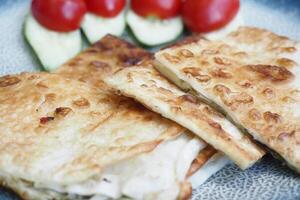 Veggie flatbread with tomatoes on a plate photo