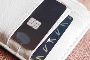 Credit card and SIM card in a wallet on wooden table photo