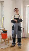 A man standing in a room with a bucket and a paint bucket video