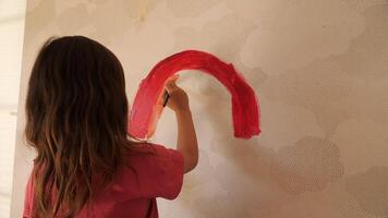 A girl painting a rainbow on a wall video