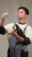 A man holding a drill and screwdriver video