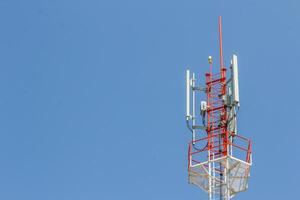 A tower with a cell phone tower and a cell phone antenna photo
