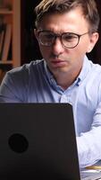 vertical Shocked scientist making discovery while working on laptop in laboratory video