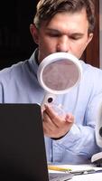 vertical Scientist examining sample with magnifying glass and microscope in laboratory video