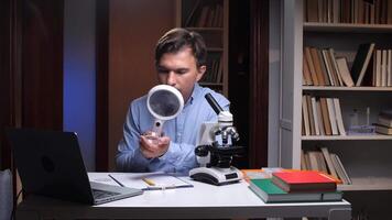 Scientist examining sample with magnifying glass in laboratory video