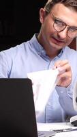 vertical Frustrated scientist throwing paper ball while working with microscope and laptop video