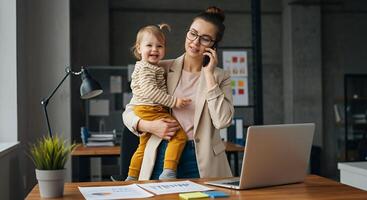 mom works with child on hands in the home office photo