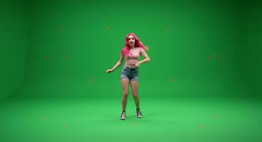 A woman in shorts and a pink wig dancing on a green screen photo