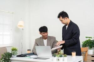 Teamwork and Idea Sharing. Two colleagues exchanging thoughts and strategies in a bright office environment. photo