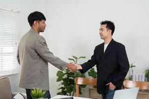 Business Agreement and Professionalism. Two colleagues shaking hands to finalize a successful business deal. photo