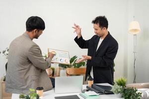 Data Presentation and Analysis. Colleagues reviewing charts and graphs during a business meeting. photo