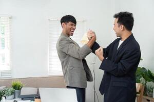 Friendly Competition and Engagement. Two men playfully engaging in an arm wrestling match at the office. photo