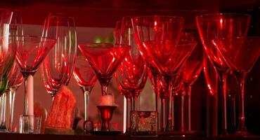 Elegant red glassware illuminated by candlelight, creating a luxurious atmosphere. photo